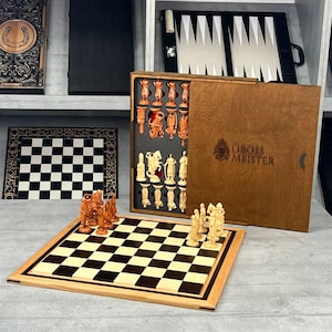 Puede incluir: Un juego de ajedrez de madera con un tablero marrón claro y casillas negras y crema. Las piezas del ajedrez están talladas intrincadamente en tonos claros y oscuros. El juego incluye una caja de madera con la inscripción "GROSS MEISTER".