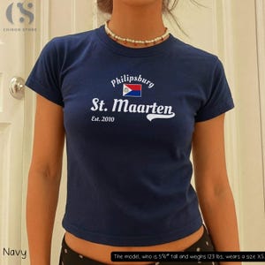 May include: A handmade, wooden cutting board with a natural wood grain. The board is rectangular with a rounded handle and a juice groove. It measures approximately 18 inches long and 12 inches wide.