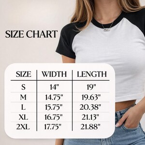 May include: A white and black baseball-style crop top. The image includes a size chart with measurements in inches: S (14" width, 19" length), M (14.75" width, 19.63" length), L (15.75" width, 20.38" length), XL (16.75" width, 21.13" length), and 2XL (17.75" width, 21.88" length).