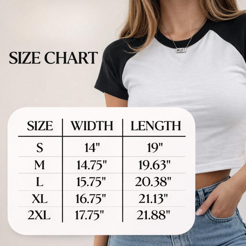 May include: A white and black baseball-style crop top. The image includes a size chart with measurements in inches: S (14" width, 19" length), M (14.75" width, 19.63" length), L (15.75" width, 20.38" length), XL (16.75" width, 21.13" length), and 2XL (17.75" width, 21.88" length).