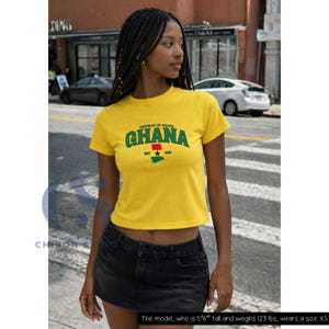 May include: A bright yellow short-sleeved t-shirt featuring the text "REPUBLIC OF GHANA" in green arched lettering above the word "GHANA" in large green letters, with a small map of Ghana in the national flag colors and "EST 1957" below.