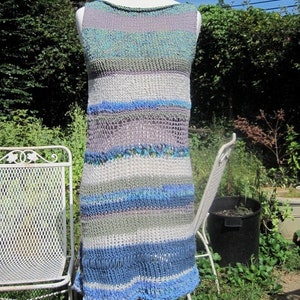 May include: A sleeveless, striped knit dress in shades of blue, green, and white. The dress has a loose fit and a slightly flared skirt.