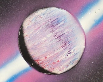 Handmade spray painted celestial image of pink planet and colorful stripes, ready for colorful wall decoration.