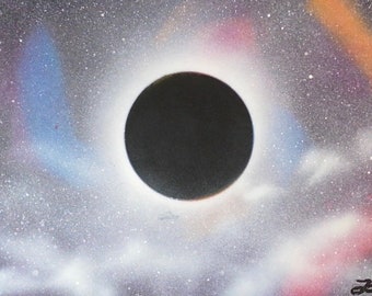 Handmade spray painted picture of solar eclipse in the dark clouds, ready for beautiful wall decoration.