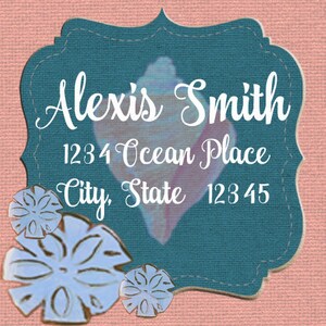 May include: A teal blue address label with a seashell design and white text. The text reads "Alexis Smith", "1234 Ocean Place", "City, State 12345".