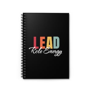May include: A black spiral notebook with the text "LEAD Role Energy" in colorful letters. The letters are in a rainbow gradient of red, orange, yellow, green, blue, and purple.