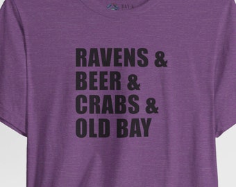 May include: Purple t-shirt with the text "Ravens & Beer & Crabs & Old Bay" printed in black.