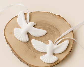 May include: Two white epoxy resin doves on a wooden surface. The doves are a symbol of peace and love. The text "Epoxy Resin Doves" and "Set of 2. Symbol of Peace & Love" is above the doves. The text "Handmade | Lightweight | Elegant" is below the doves.