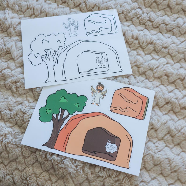 May include: Two sheets of paper with illustrations of an angel, a tree, a tomb, and a rock. One sheet is colored, featuring green, brown, and orange hues. The other sheet is a black and white outline of the same images.
