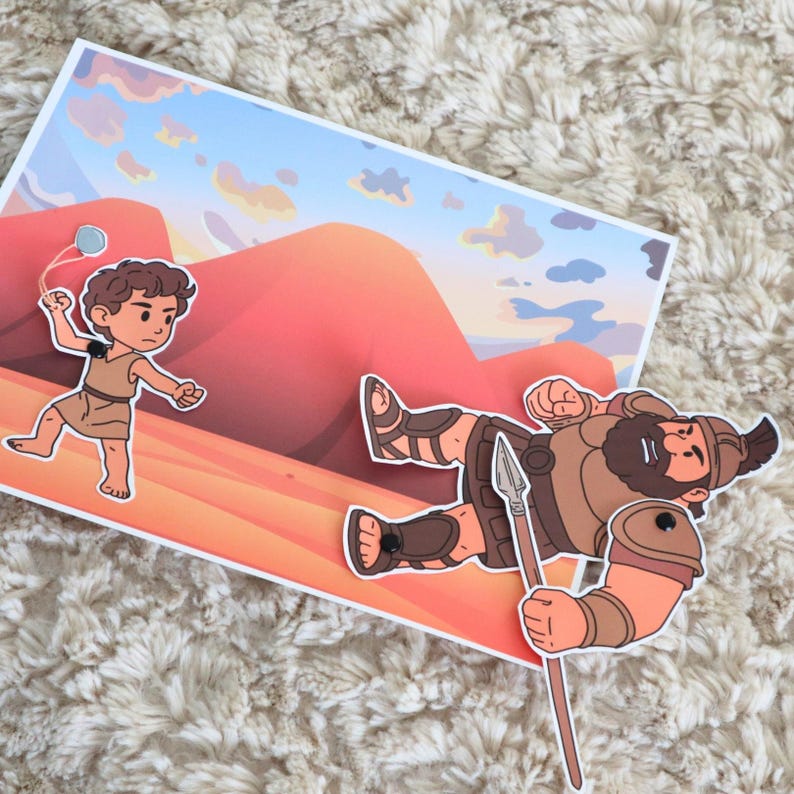 May include: A colorful illustration depicting a biblical scene. A young boy with a slingshot faces a fallen giant holding a spear. The background features a desert landscape with a blue sky and orange and red mountains.