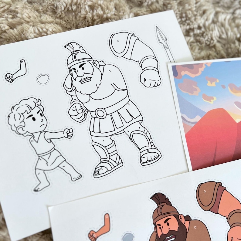 May include: Black and white illustrations of biblical characters, including a giant warrior and a young boy, are featured on paper cutouts. A spear and additional character pieces are also visible. The illustrations are designed for a children's craft project.