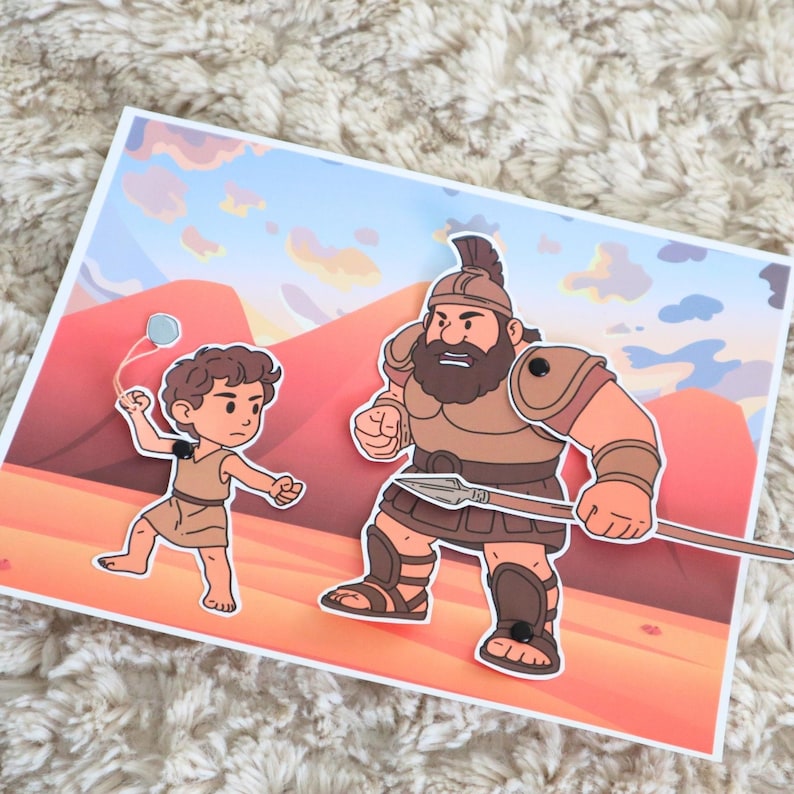 May include: A colorful illustration depicts a biblical scene with two cartoon figures. One figure is a young boy with a slingshot, and the other is a large warrior holding a spear. The background features a desert landscape with mountains.