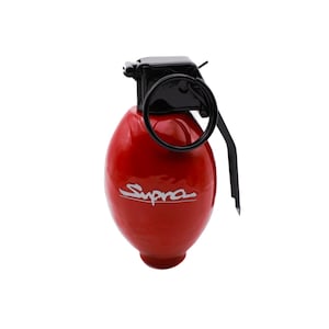 May include: A red grenade-shaped keychain with a black handle and the word "Supra" printed in white on the side.