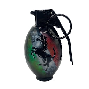 May include: Black grenade-shaped keychain with a green, white, and red design and a black horse logo.