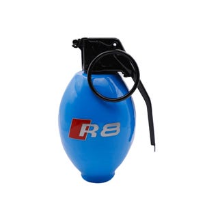 May include: A blue grenade-shaped keychain with a black ring and handle. The keychain has a red and silver "R8" logo.