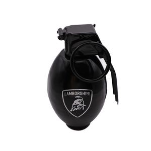 May include: Black grenade-shaped bottle with a silver Lamborghini logo featuring a charging bull. The logo is surrounded by the text "LAMBORGHINI".