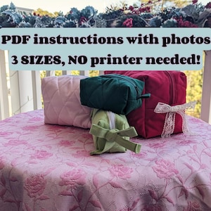 May include: Three quilted fabric zippered pouches in pink, green, and red. The pouches are stacked on top of each other on a pink floral tablecloth. The text "PDF instructions with photos 3 SIZES, NO printer needed!" is displayed above the pouches.