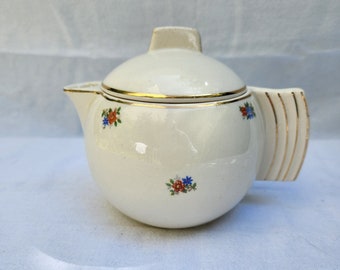 Pretty round art deco teapot from the French factory of Badonviller. Ancient.