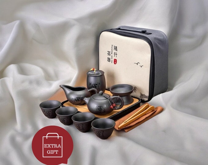 A travel-friendly Chinese Kung Fu tea set made of sand ceramic, featuring a purple sand pot with infuser, porcelain teapot, and ceramic tea