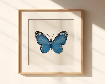 May include: A framed print of a blue butterfly with white spots on its wings. The butterfly is centered on a white background.