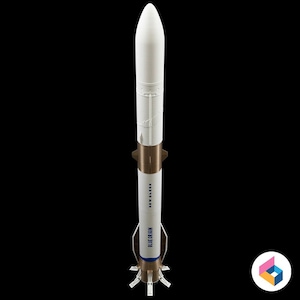 May include: A white and brown model rocket with the text "BLUE ORIGIN" and "NEW SHEPARD" printed on the side. The rocket has a pointed nose cone and multiple fins at the base. The rocket is set against a black background.
