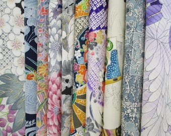 May include: A collection of vertical fabric strips featuring diverse patterns including floral motifs, geometric grids, and abstract shapes in a vibrant color palette of purple, blue, orange, pink, white, and black with metallic gold accents.