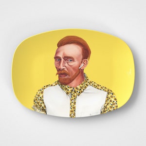 May include: A yellow rectangular decorative plate featuring a portrait of Vincent van Gogh wearing a white shirt, a yellow patterned shirt, and a wireless earbud. The plate has a yellow background.