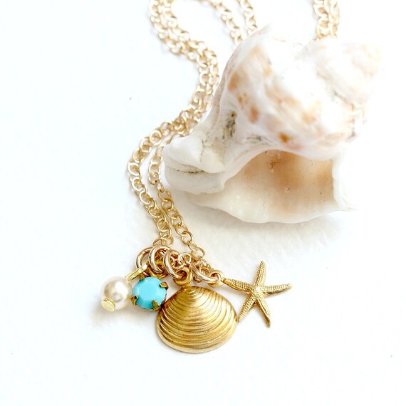 Items similar to Little Golden Seashell Charm Necklace on Etsy