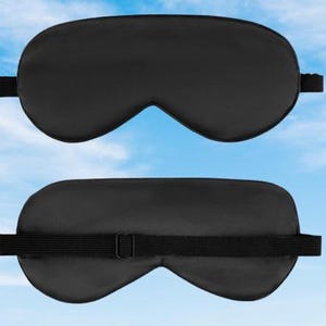 May include: A black sleep mask with an adjustable strap. The mask is made of a soft, comfortable material and is designed to block out light.