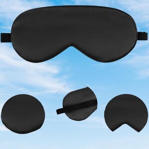 May include: Black sleep mask with an adjustable strap. The mask is made of a soft, comfortable material and is designed to block out light.