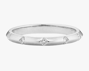 May include: A silver band ring with five small diamonds set into the band.