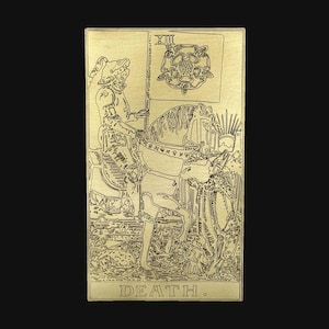 May include: A rectangular gold-toned metal card featuring an engraved line art illustration of a knight on horseback holding a flag with a rose emblem. The Roman numeral XIII is at the top, and the word DEATH is printed at the bottom of the card.