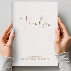 May include: A white hardcover notebook with the text Teacher NOTES in brown cursive and block lettering. Below, the text HANNAH SMITH and LIBERTY HEIGHTS SCHOOL is printed in brown block letters. The cover has a clean, minimalist white finish.