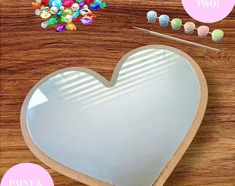 May include: A heart-shaped DIY painting kit with a wooden frame and a mirrored surface. The kit includes paint pots, a paintbrush, and colorful gems. Text on the image reads "DIY SET FOR TWO!" and "PAINT & HANG".