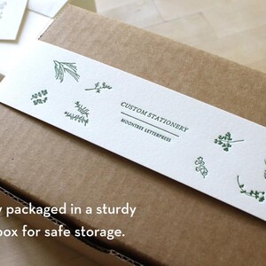 Botanical-illustrated belly band wrapped around kraft box, packaging for personalized stationery set