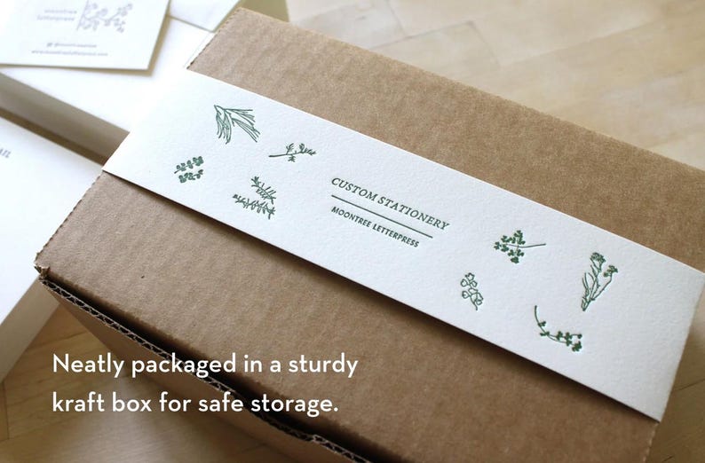 Botanical-illustrated belly band wrapped around kraft box, packaging for personalized stationery set