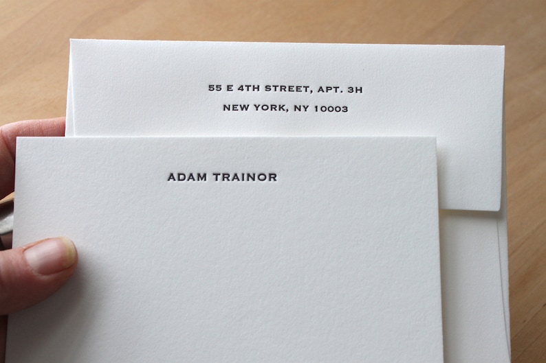 White card with white envelopes, Close‑up of deep letterpress impression on thick cotton paper.