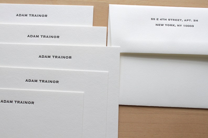 Custom letterpress cards with envelope, 118 lb text weight, neatly stacked.