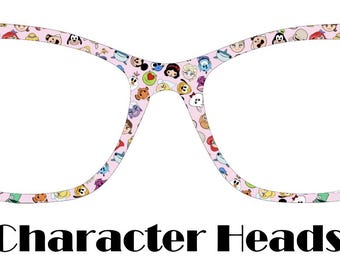 May include: Cat-eye style eyeglasses with a light pink frame, adorned with colorful cartoon character heads. The text "Character Heads" is displayed in black below the glasses.