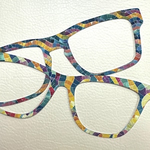 May include: Two pairs of colorful glasses with a mosaic pattern. The glasses are made of a hard plastic material and have a rectangular shape.