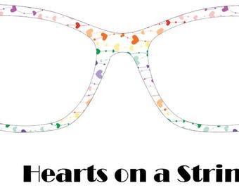 May include: White cat-eye glasses with a rainbow heart pattern. The glasses have a white frame and a rainbow heart pattern on the frame. The text "Hearts on a String" is below the glasses.