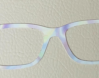 May include: A pair of white eyeglasses with a tie-dye pattern. The glasses have a rectangular frame.