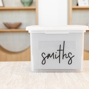 May include: A clear plastic storage box with a black label that says "smiths" on it.