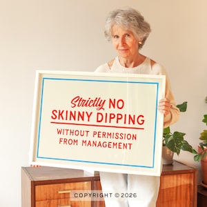 May include: A framed sign with the text "Strictly NO SKINNY DIPPING WITHOUT PERMISSION FROM MANAGEMENT" in red and blue lettering. The sign is held by a person.