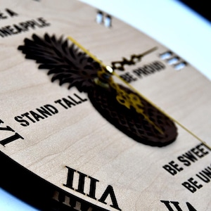 May include: A wooden clock with a pineapple design and the text "Be a Pineapple, Stand Tall, Be Proud, Be Sweet, Be Unique".