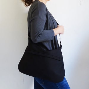 Black Medium Canvas Crossbody Bag with Zipper and outside Pocket.