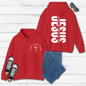 May include: Red hoodie with a white cross and the text "The Way The Truth The Life" on the front and the text "JESUS THE WAY THE TRUTH THE LIFE" on the back.