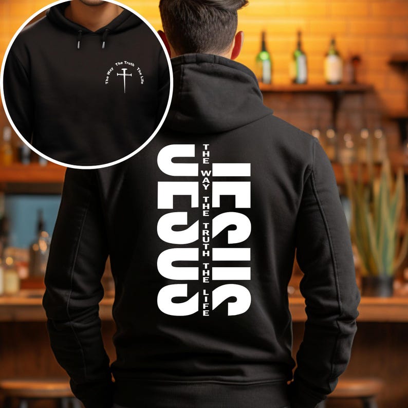 May include: Black hoodie with a white graphic on the back that says "JESUS" with the words "THE WAY", "THE TRUTH", and "THE LIFE" vertically aligned on the right side of the graphic. The front of the hoodie has a small white cross with the words "THE WAY", "THE TRUTH", and "THE LIFE" in a circle around the cross.