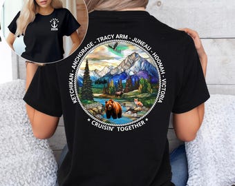 May include: Black t-shirt with a circular graphic on the back featuring a bear in a river, mountains, and the text "Cruisin' Together." The shirt also has text around the graphic that says "Ketchikan - Anchorage - Tracy Arm - Juneau - Hoonah - Victoria."
