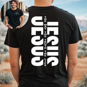May include: Black t-shirt with white text that reads "JESUS" vertically, with the words "THE WAY", "THE TRUTH", and "THE LIFE" written vertically beside it.